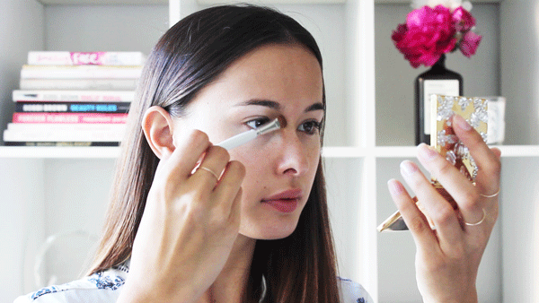 girl putting on concealer gif
