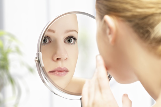 Woman looking in mirror Woman looking in mirror