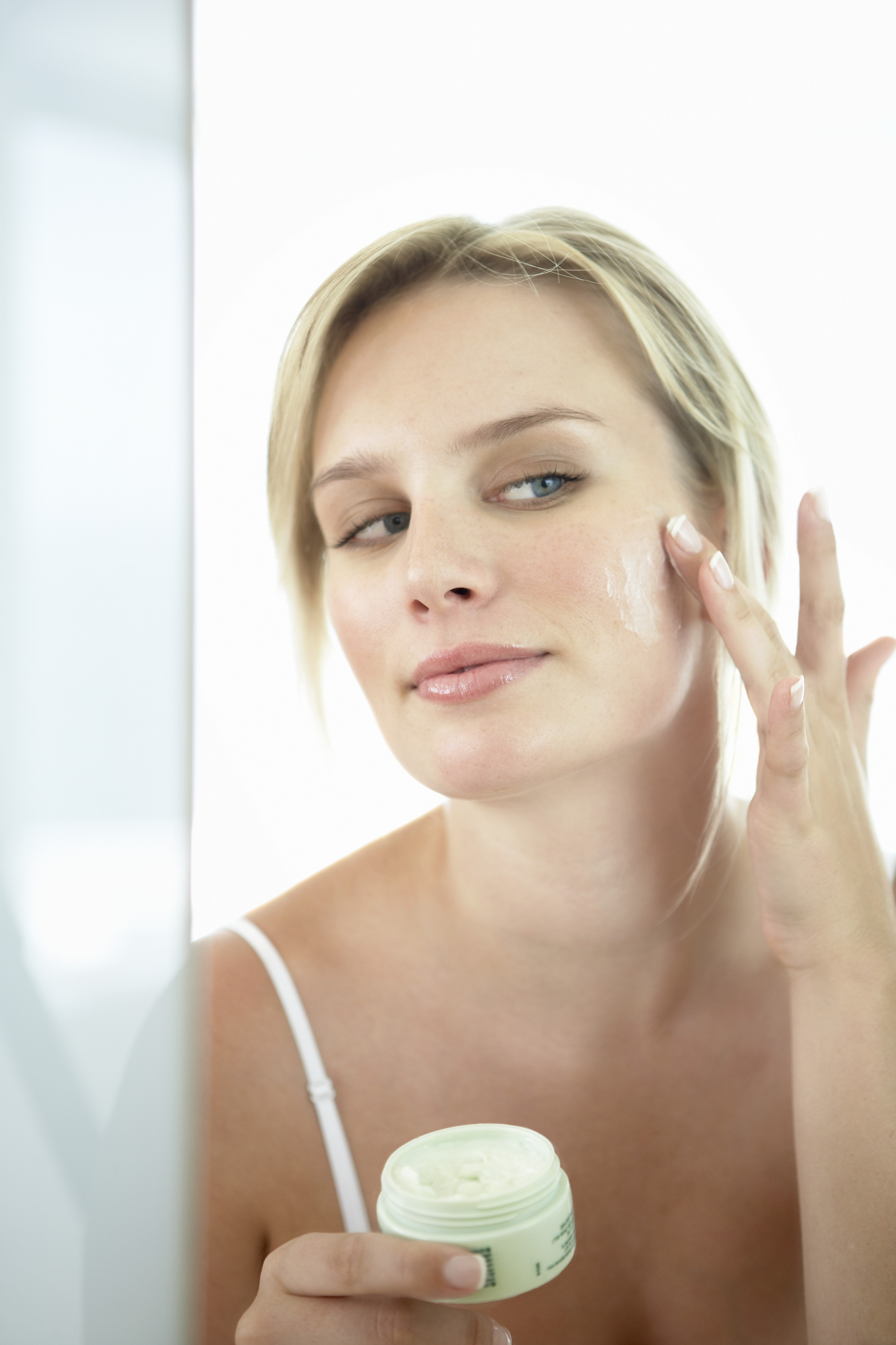 woman applying face cream woman applying face cream