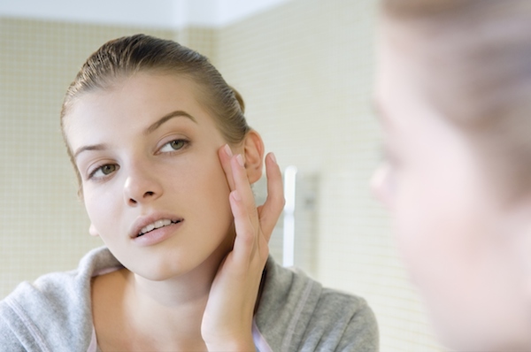 Woman touching face Woman touching face